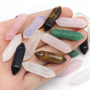 Hand holding various natural crystal double pointed hexagonal prisms for DIY jewelry