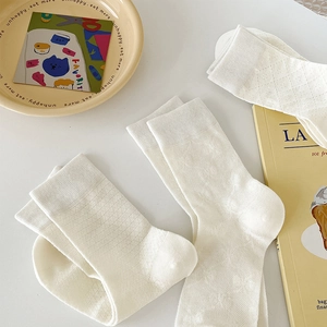 Breathable cream cotton crew socks with lattice knit pattern and delicate bow accent