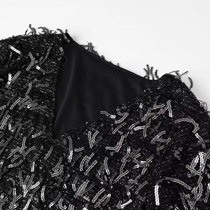 Women's black V-neck mini dress featuring shimmering sequins and dynamic fringe details