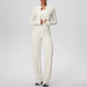 Detail of three-piece yoga set featuring zip jacket with thumbholes and wide-leg pants
