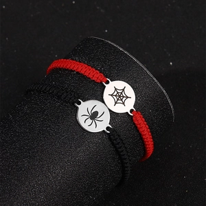 Detail of adjustable woven Halloween bracelets with spider and web engraved metal discs