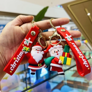 Detail of Christmas Santa Claus keychain with red strap and golden metal ring