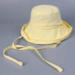 Detail of yellow cotton sun hat with adjustable chin strap for outdoor sun protection