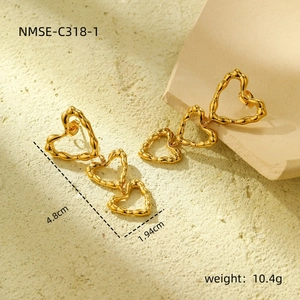 Detailed view of triple heart gold stainless steel drop earrings showing 4.8cm length size