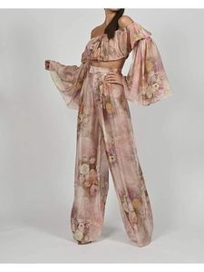Macro detail of floral chiffon off-shoulder crop top and matching wide-leg trousers
