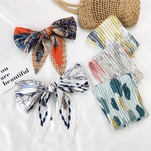 Pleated silk scarves collection in various floral and geometric patterns for women