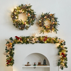 Green Christmas wreath and garland set with gold flowers and warm LED lights
