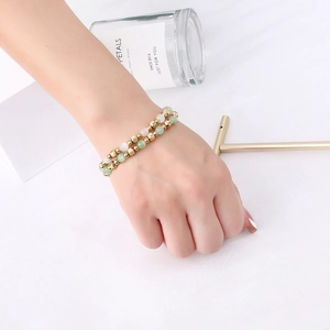 Detail of beaded double-layer bracelet with opal-like beads and engraved golden beads