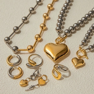 Mix of gold and silver stainless steel heart necklaces, earrings, and twisted rings