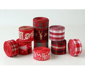 Detail of Christmas ribbons with snowflake and elk patterns on faux burlap fabric texture