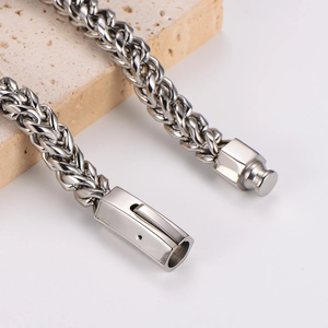 8mm silver stainless steel woven chain bracelet for men with box clasp on stone pedestal