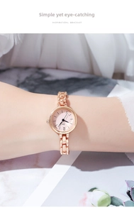 Close-up of rose gold minimalist bracelet watch with round dial on a female wrist