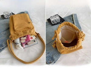 Detail showing inner capacity of yellow corduroy crossbody bag with drawstring