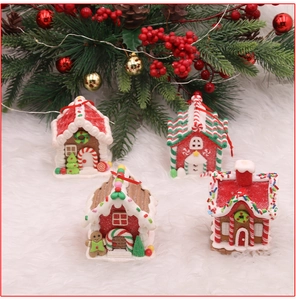 Detailed set of four miniature gingerbread clay houses with festive candy and snow accents