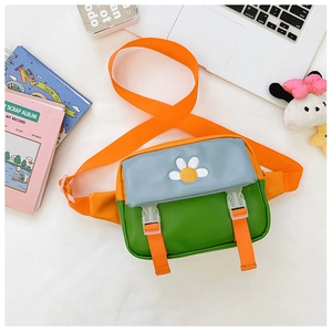 Detail of colorful kids crossbody bag featuring white daisy embroidery and plastic buckles