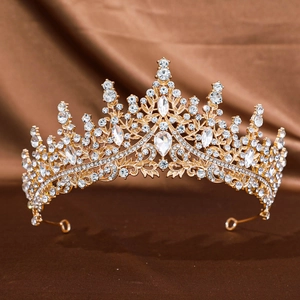 Detailed macro view of a gold bridal tiara featuring intricate floral crystal patterns