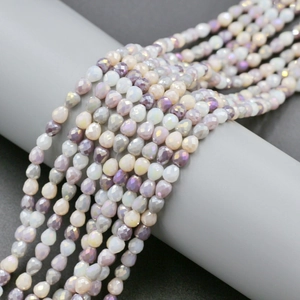 Detailed view of 4mm multifaceted teardrop glass beads in purple and grey gradient tones