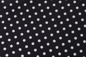 Close-up of high-quality black and white polka dot textile fabric with smooth texture