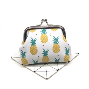 Detailed view of white canvas coin purse with pineapple print and silver metal clasp