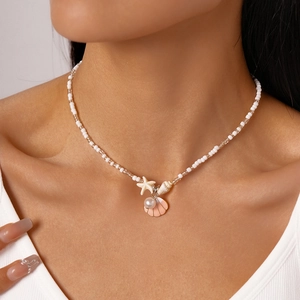 Summer ocean themed necklace with starfishes, seashells and faux pearls on a beaded chain