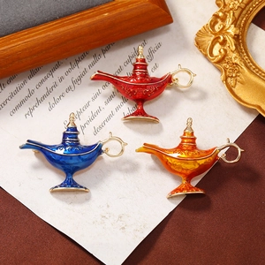 Detailed view of vintage enamel Aladdin lamp brooches in red, blue and orange colors
