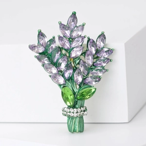 Detail of lavender crystal brooch with purple rhinestones on white display base