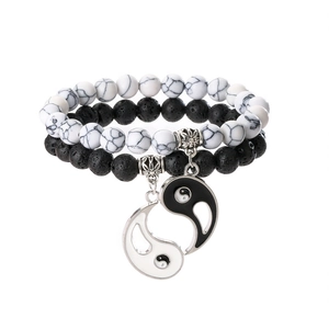 Detail of Yin Yang couples bracelet set featuring black lava and white marble beads