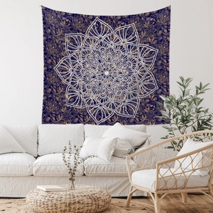 Detail of bohemian mandala tapestry with golden patterns on navy background over a sofa