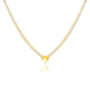 Macro shot of gold-plated tennis necklace with a yellow heart zircon gemstone and crystals
