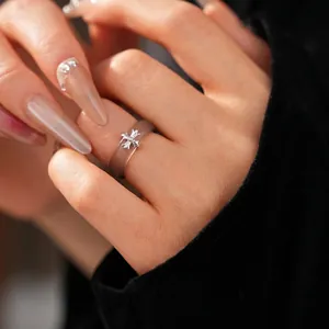Minimalist resin chalcedony ring with gothic cross motif worn on a hand index finger
