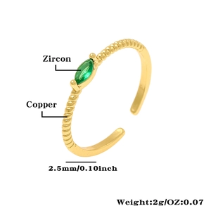 Detail of twisted copper ring with marquise green zircon inlay and 18K gold plating