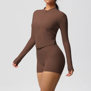 Detail of slim fit yoga set with full zip stand collar top and high waist sports shorts