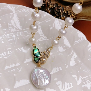 Baroque pearl necklace featuring a zircon butterfly pendant with a blue shell inlay design