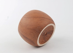 Detail view of round wood grain ceramic planter with drainage hole and bamboo tray