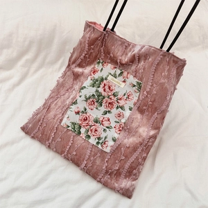 Detailed close-up of pink velvet tote bag with rose floral patch and wavy texture