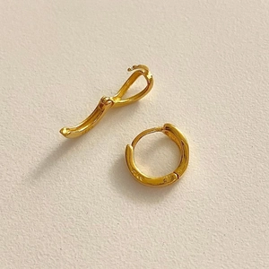 Detail of polished S925 silver hoop earrings in gold finish showing secure clasp
