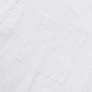 Close-up of white linen shirt front pocket showing natural fabric texture and stitching