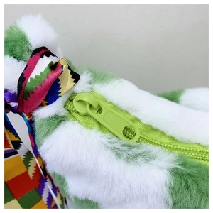 Close-up of fluffy green faux fur texture with vibrant geometric patterned ribbon handle