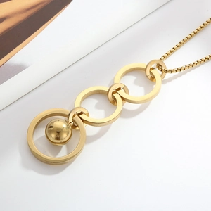 Close-up of golden titanium steel necklace with triple ring and bead pendant details