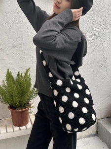 Gros plan du sac fourre-tout à pois en peluche avec texture douce et bandoulière large