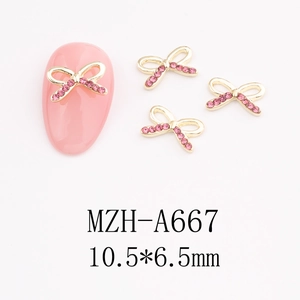 Detail of pink rhinestone bow nail art charm with gold metal frame, 10.5x6.5mm size