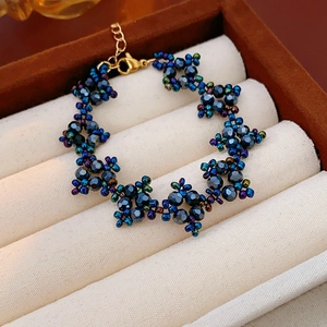 Detailed shot of handmade beaded bracelet with blue-purple facets in a jewelry box