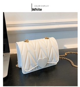 Detailed view of white heart-shaped silicone crossbody bag with textured diamond pattern