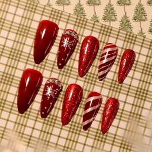 Unghie natalizie rosse con glitter, fiocchi di neve e strisce candy cane in forma a mandorla