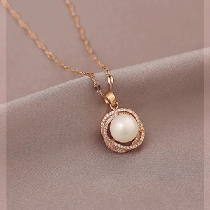 Detailed macro view of a rose gold wheat pearl pendant with micro-set cubic zirconia crystals