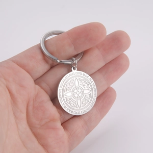 Macro shot of stainless steel keychain featuring a celtic knot and engraved runic symbols