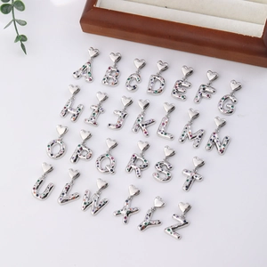 Detailed grid of 26 silver heart alphabet pendants with colorful cubic zirconia inlays