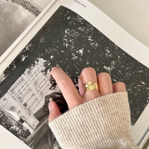 Minimalist 925 silver irregular lava gold ring shown on model with knit sweater