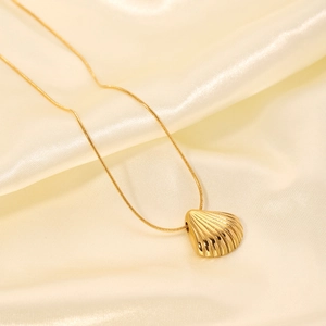 Minimalist gold stainless steel snake chain necklace with glossy shell pendant on silk