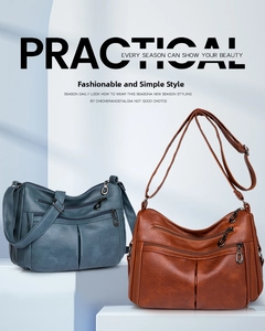 Detail view of multi-compartment crossbody bags in blue and brown soft leather finish